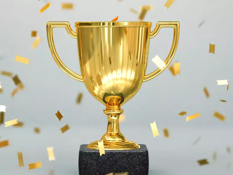 Image of a trophy and gold confetti
