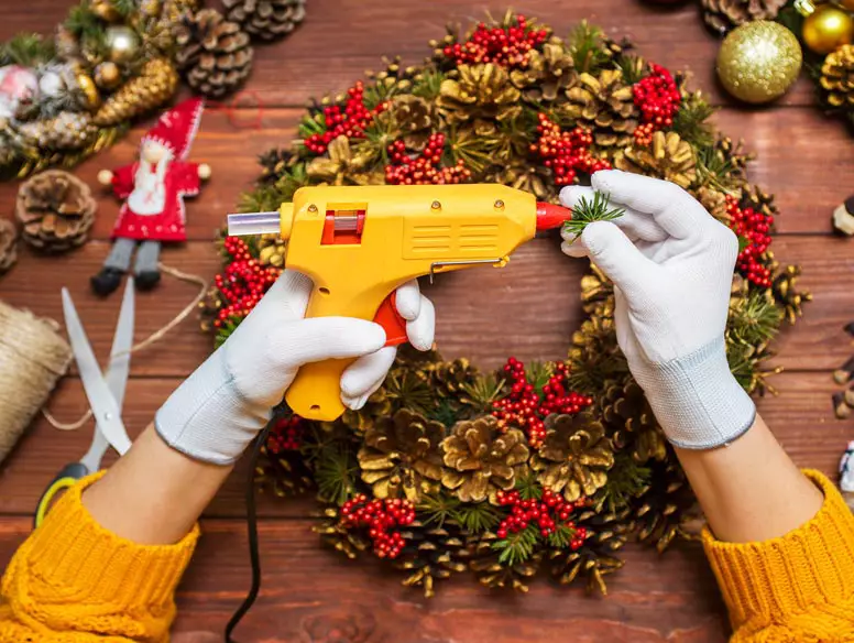 Photo of someone making a holiday wreath