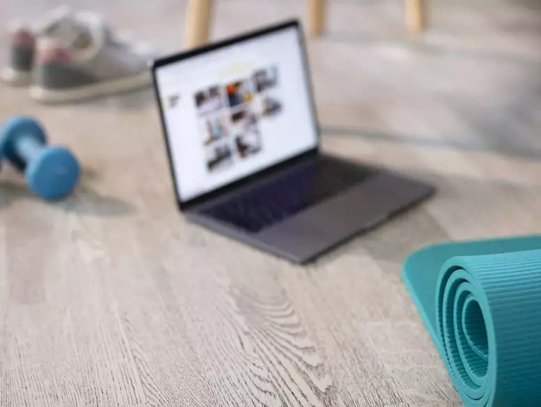 Photo of laptop and exercise equipment
