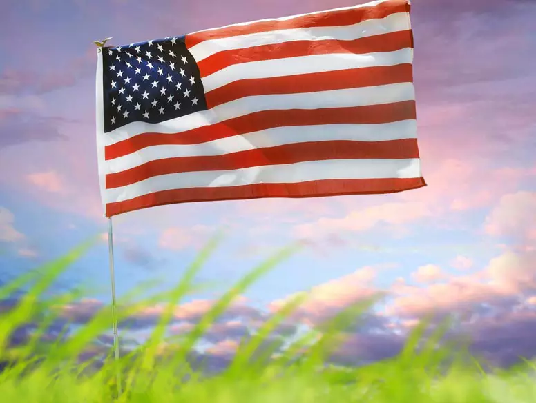 American flag against a multicolored sky