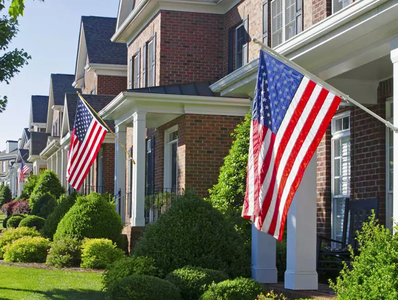 Row of homes with American flags